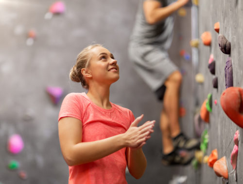 Teen girl at an indoor rock climbing gym.