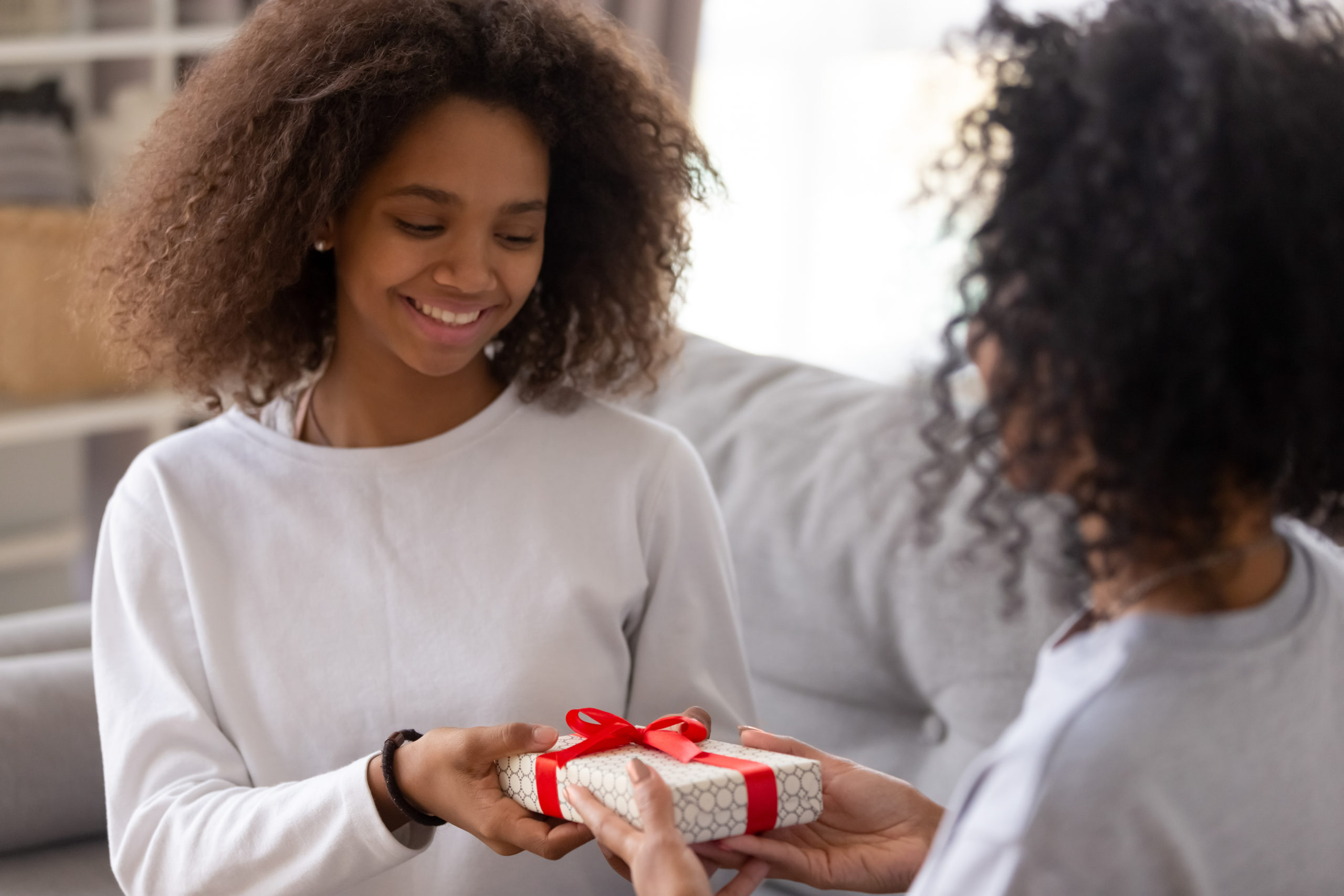 Young teen receiving a self-care gift for the holidays.